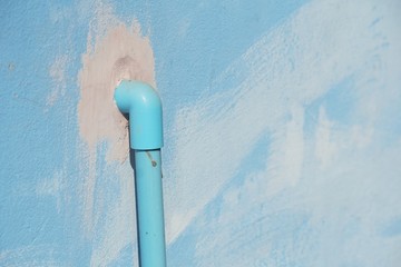 pvc pipe on blue cement wall texture