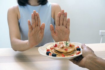 The women used to push the dessert plate with the people.  Do not eat desserts for weight loss.
