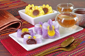 Thai dessert : Layer sweet cake (or Khanom Chan) Thai traditional dessert in beautiful orchid flowers shaped filling with red bean paste. One of nine famous Thai auspicious desserts in Thailand.