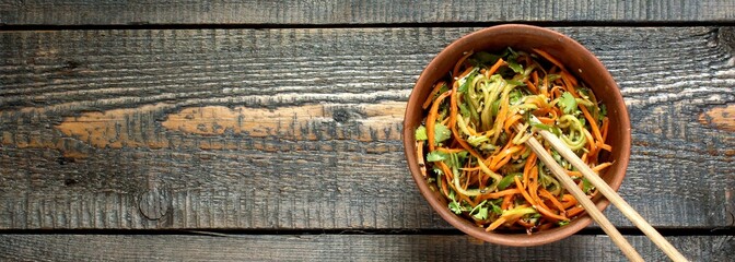 Asian cucumber and carrot salad with sesame, garlic, soy sauce and cilantro. top view. place for text. copy space.