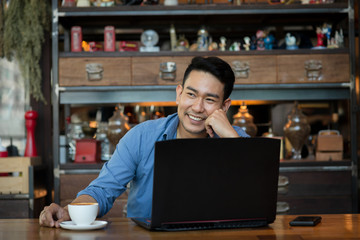 Asian man in deep thought closeup in profile with laptop.