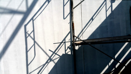 Naklejka na ściany i meble Shadow wall construction scaffolding 