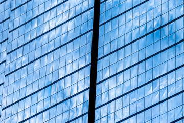 Fototapeta na wymiar Blue glass windows of office building