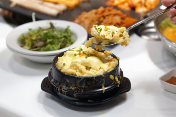 Korean steamed egg casserole (Gaeran Jjim) - The main ingredients included egg, water, shrimp. After finished steaming add more chopped spring onion and cheese, served in hot stone bowl.