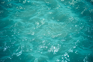 Abstract bokeh from light in the blue water