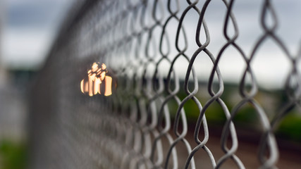 Closeup of chain link fence by railroad tracks