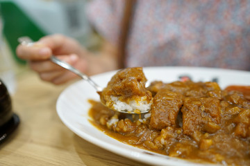 Japanese curry rice with fried pork cutlet and pork sausages.