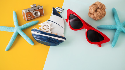 Sunglasses and accessories on yellow and blue background