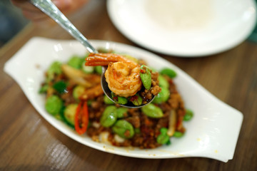 Stir-Fried Twisted cluster bean (Bitter bean or Stink bean) with shrimps paste, Traditional Thai food recipe, Popular in Thailand.