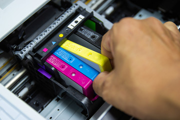 Technicians are installing the color printer inkjet cartridge