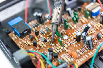 Fototapeta na wymiar soldering iron for repairing electronic of the computer circuit board