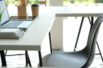 computer tablet pencil coffee cup on office desk. workplace interior