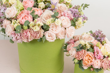 Two Beautiful spring bouquets in head box. Arrangement with mix flowers. The concept of a flower shop, a small family business. Work florist. copy space
