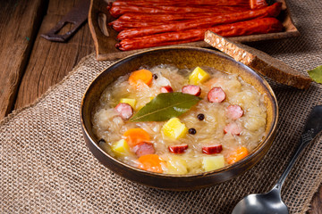 rustic sauerkraut soup with bacon and sausage