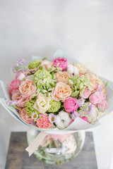 delicate, pastel coloured Small Beautiful bouquet of mixed flowers. Floral shop concept . Beautiful fresh cut bouquet. Flowers delivery