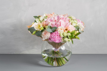 delicate, pastel coloured Small Beautiful bouquet of mixed flowers. Floral shop concept . Beautiful fresh cut bouquet. Flowers delivery