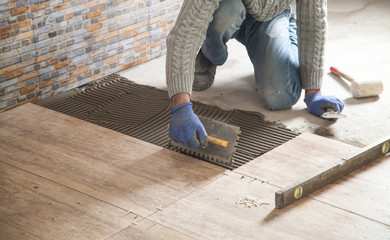 Laying floor ceramic tile. Renovating the floor