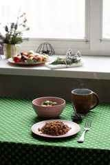 A healthy breakfast: a plate of buckwheat, a salad, a bowl of jam and tea.