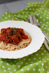 A delicious dinner: a plate of spaghetti with bolognese sauce.