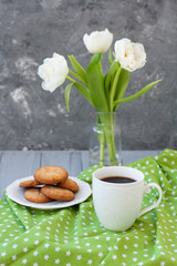 A tasty snack: a cup of coffee and a plate of cookies.