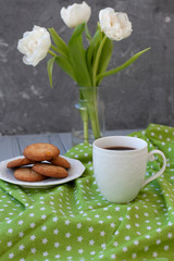 A tasty snack: a cup of coffee and a plate of cookies.