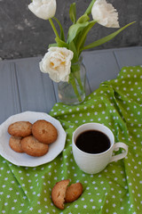 A tasty snack: a cup of coffee and a plate of cookies.