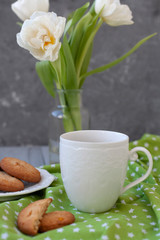 A tasty snack: a cup of coffee and a plate of cookies.
