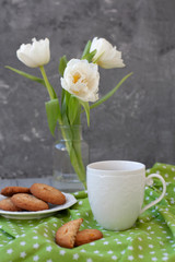 A tasty snack: a cup of coffee and a plate of cookies.