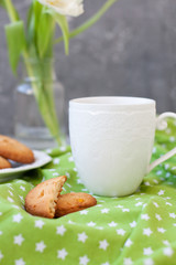 A tasty snack: a cup of coffee and a plate of cookies.