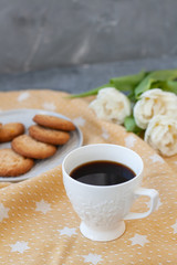 A tasty snack: a cup of coffee and a plate of cookies.