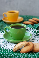 A break for two: cups of coffee, stacks of cookies