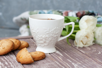 A tasty snack: a cup of tea and a stack of cookies.