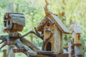 Hand made wooden bird house nest  in public Park , hand wood shelter for birds .