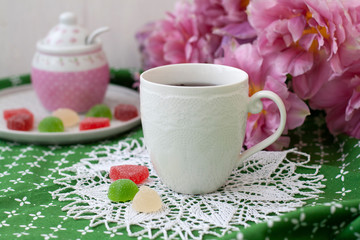 A tasty break: a cup of tea with jelly beans.