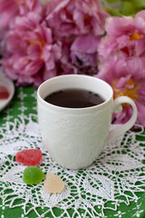 A tasty break: a cup of tea with jelly beans.