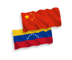 Obraz premium National vector fabric wave flags of Venezuela and China isolated on white background 1 to 2 proportion.