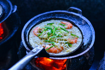 Cooking Vietnamese traditional seafood pancake