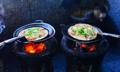 Cooking Vietnamese traditional seafood pancake