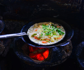 Cooking Vietnamese traditional seafood pancake