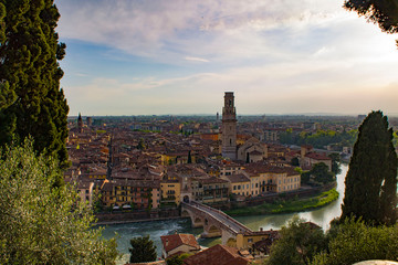 Ponte Pietra Bridge on the Adige River in Verona, Italy. Evening city. Sunset with roofs, towers, bell tower. View from above.