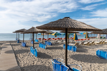 Fototapeta na wymiar Umbrellas on Kardamena city beach in Kos island, Greece.