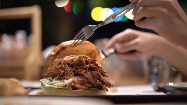 pulled pork burger on dinner table with beautiful light bokeh