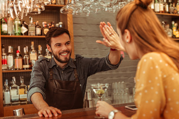 Bearded man giving a high five to a red-haired woman