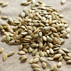 Roasted pumpkin seeds on cloth, low angle view. Close-up.