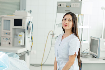 good looking brunette female intern in the hospital. close up photo. copy space. education