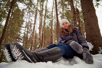 Girl in a pine forest on a winter day