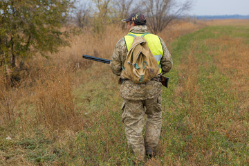 Hunters with a german drathaar and spaniel, pigeon hunting with dogs in reflective vests	