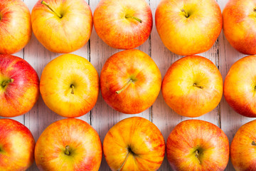 apple fruits in a row, white wooden table background