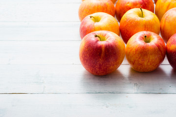 apple fruits in a row, white wooden table background