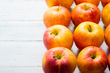 apple fruits in a row, white wooden table background